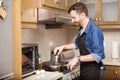 Man cooking breakfast at home Royalty Free Stock Photo