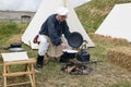 Man cooking on campfire