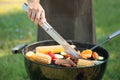 Man cooking delicious meat and vegetables on barbecue grill outdoors Royalty Free Stock Photo