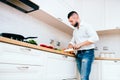 man cooking. Details of modern cook with knife and kitchen dish Royalty Free Stock Photo