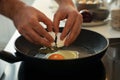 Man cooking eggs in frying pan, closeup Royalty Free Stock Photo