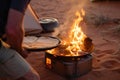 man cooking flatbread on a desert campfire stove Royalty Free Stock Photo