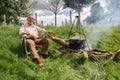 Man cooking food around a camp fire at the Appleby Horse Fair