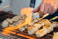 A Man Is Cooking Fresh Tuna Sticks On A Grill Royalty Free Stock Photo