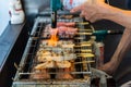 A Man Is Cooking Fresh Tuna Sticks On A Grill Royalty Free Stock Photo