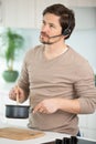 man cooking with headset standing at kitchen Royalty Free Stock Photo