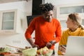 Man cooking and his smiling girlfriend looking at him Royalty Free Stock Photo