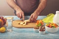 Man cooking at home preparing fruit salad Royalty Free Stock Photo