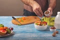 Man cooking at home preparing fruit salad