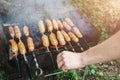 Man is cooking homemade grilled sausages outdoors. Tasty food for barbecue party Royalty Free Stock Photo