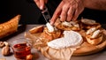 Man cooking Italian bruschetta with baked pear, honey, walnut and brie camembert cheese Royalty Free Stock Photo