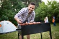 Man cooking meat on barbecue grill at outdoor summer party Royalty Free Stock Photo