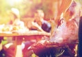 Man cooking meat on barbecue grill at summer party Royalty Free Stock Photo