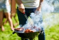 Man cooking meat on barbecue grill at summer party Royalty Free Stock Photo