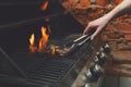 Man cooking meat steaks on professional grill outdoors Royalty Free Stock Photo