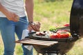Man cooking meat and vegetables on barbecue grill Royalty Free Stock Photo
