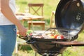 Man cooking meat and vegetables on barbecue grill Royalty Free Stock Photo