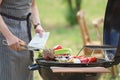 Man cooking meat and vegetables on barbecue grill outdoors Royalty Free Stock Photo