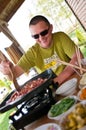 Man cooking outdoors Asian style food, korean meat on the portable stove