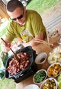 Man cooking outdoors Royalty Free Stock Photo