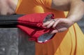 Man cooking outside reaches for heavy duty hot mitts with hand with black ring - closeup - selective focus