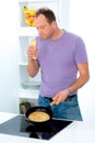 Man cooking pancake in the kitchen