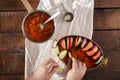 Man cooking ratatouille on a wooden table Royalty Free Stock Photo