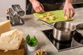 The man is cooking Ravioli with spinach and Parmesan cheese