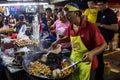 Man cooking rice cake at PJ Pasar Malam