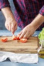 Man cooking salad In the home kitchen