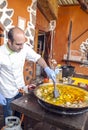 Man cooking a seafood paella