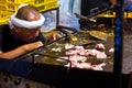 man cooking on street market during a matsuri