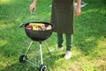 Man cooking tasty vegetables and meat on barbecue grill outdoors Royalty Free Stock Photo