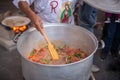 Man cooking a typical Mexican meal known as `chicharron en rajas` in a typical comal l