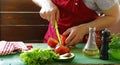 Man cooking vegetable salad (tomatoes, lettuce, cucumbers) Royalty Free Stock Photo