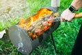 Man cooking vegetables on grill outdoors. Vegan barbecue on fire in summer. Good time. Cooking food in the nature. Healthy Royalty Free Stock Photo