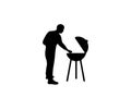 Man cooks on the grill, barbecue, barbecuing meat on the outdoors, silhouette, graphic design. Food, meal, eat, eating, cooking an