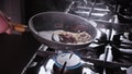 Man Cooks Meal - tossing the pan with juicy meat and searing onions