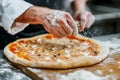 Man cooks traditional pizza in pizzeria\'s kitchen
