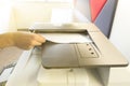 Man copying paper from Photocopier with access control for scanning key card sunlight from window Royalty Free Stock Photo