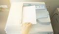 Man copying paper from Photocopier sunlight from window Royalty Free Stock Photo