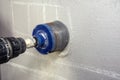 Man with cordless hand drill drilling a hole in concrete Royalty Free Stock Photo