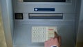 Man correcting pin code on ATM keyboard, transfer funds between bank accounts Royalty Free Stock Photo