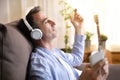 Man on the couch at home listening to music placidly Royalty Free Stock Photo