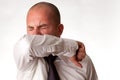 Man Coughing into Elbow