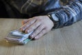 Man count money cash in his hand. Finance, saving, salary and donate concept Royalty Free Stock Photo