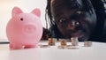 Man counting his savings. Close up of piggybank surrounded by coins. Investing decision