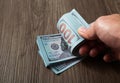 Man counting paper dollar banknotes. 100 usd dollar bills in hands close up