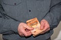 Man counting paper euro banknotes