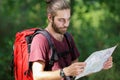 Man in countryside with backpack and map Royalty Free Stock Photo